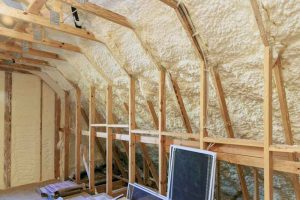 technician applying spray foam insulation