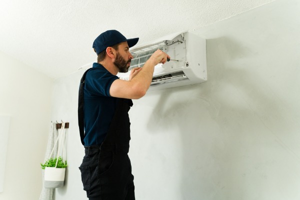 technician servicing ductless mini-split system