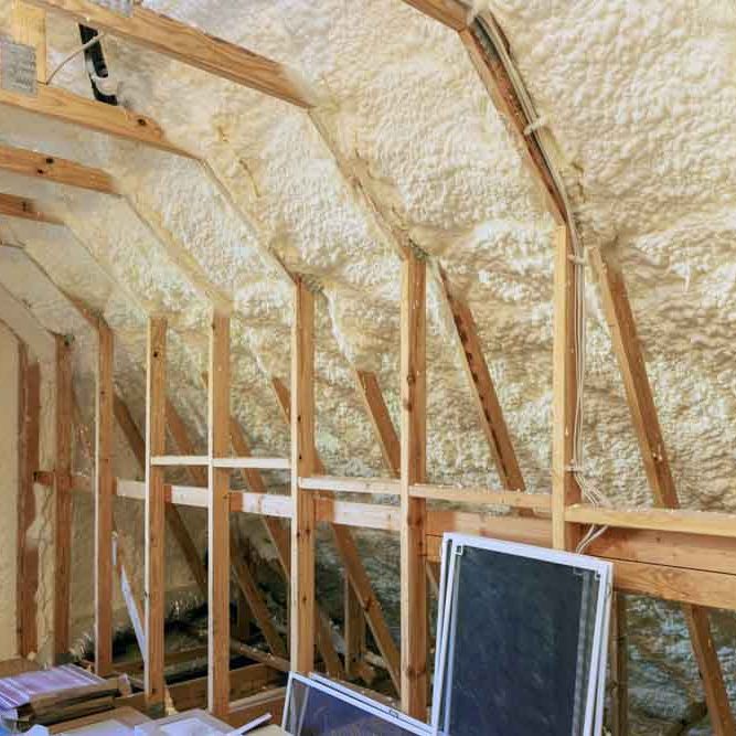 technician applying spray foam insulation technician applying spray foam insulation