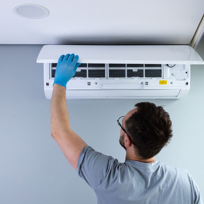 technician inspecting an AC system