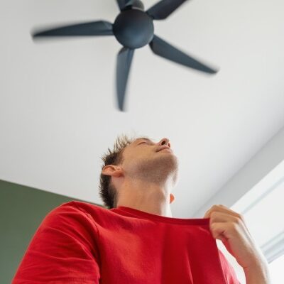 man cooling off under ceiling fan