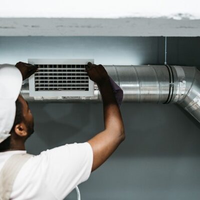 technician installing hvac air vent