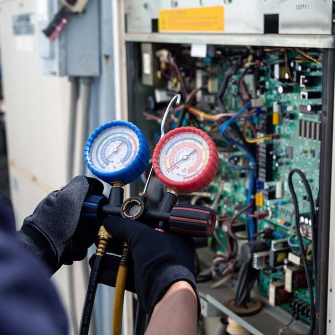technician tinkering with an HVAC unit